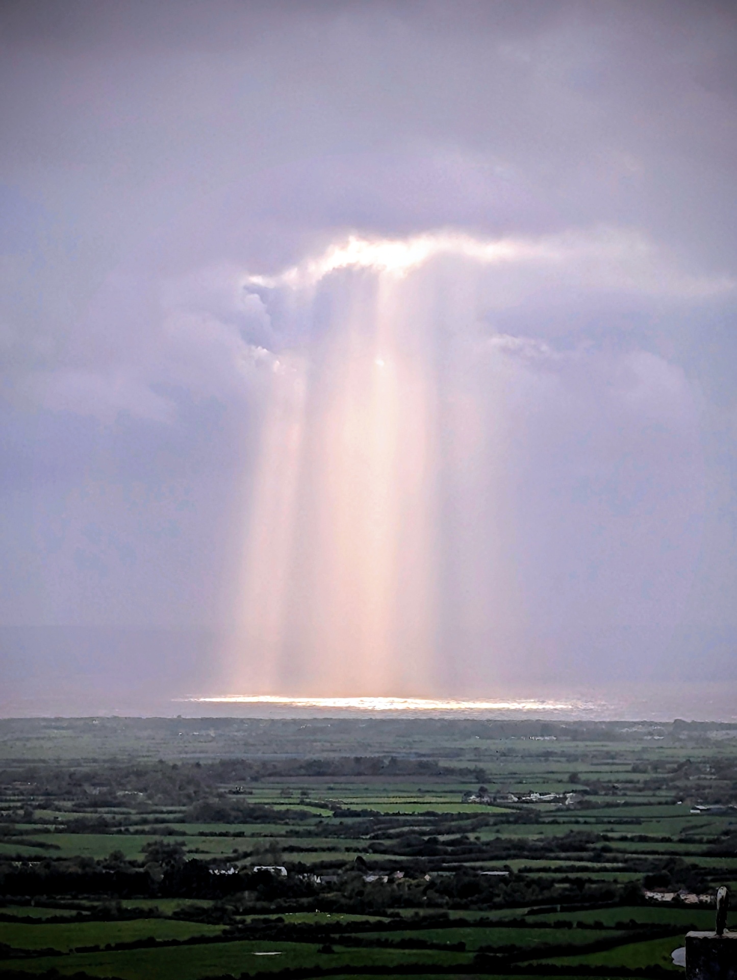 Beam of sunlight breaking through cloud over the Somerset Levels